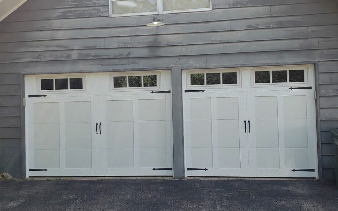 a pair of white garage doors with black hinges