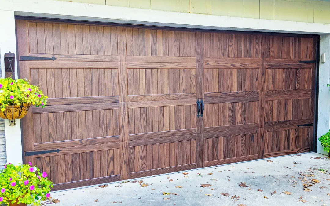 a wooden garage door with plants hanging on it