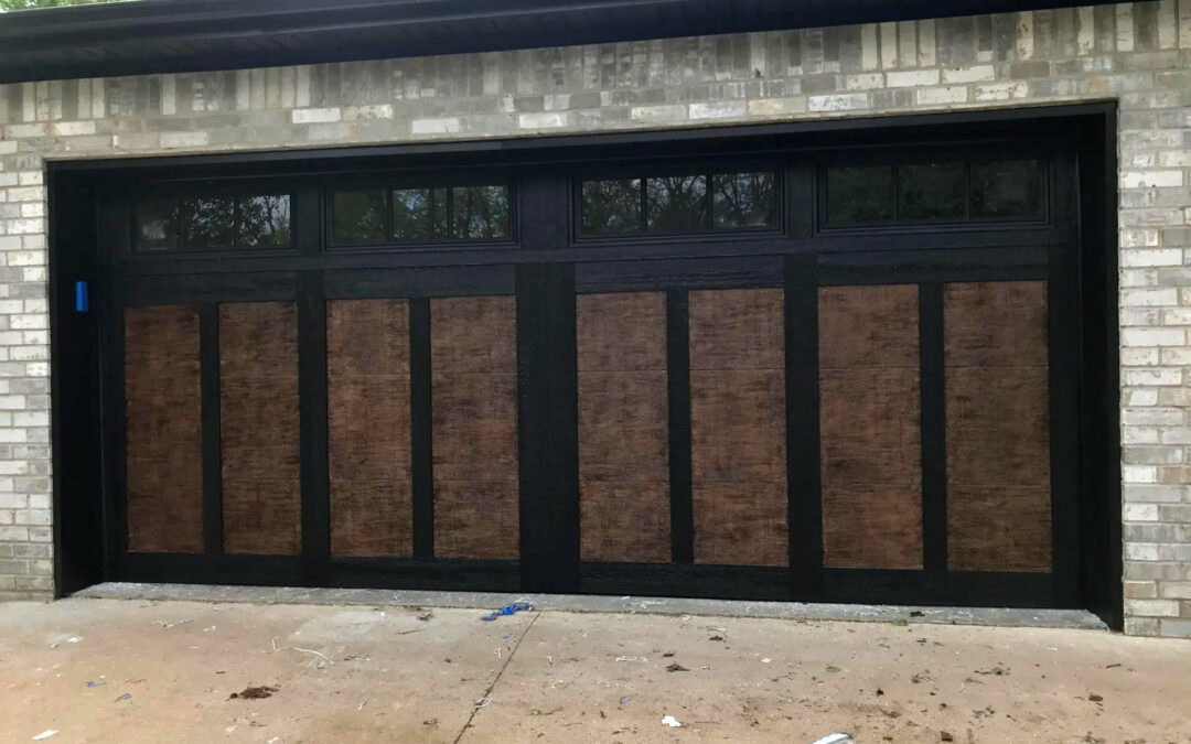 a black garage door with paneling and windows